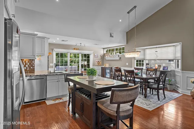 a kitchen with stainless steel appliances granite countertop a stove and cabinets