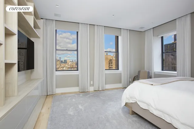 a spacious bedroom with a bed and a window