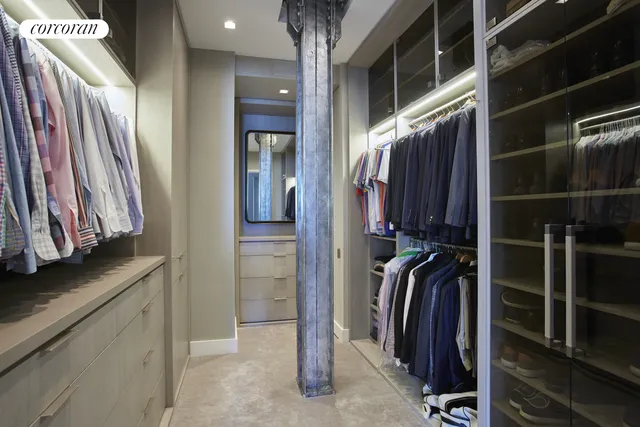 a view of walk in closet with clothes and shoes
