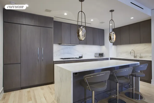 a kitchen with a table chairs microwave and cabinets