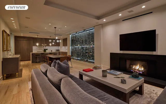 a living room with furniture and view of kitchen