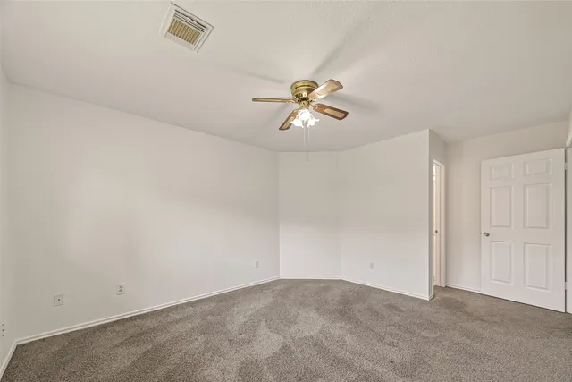 a bathroom with a double vanity sink a toilet and a large mirror