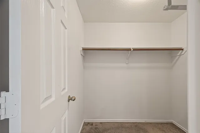 a view of a room with wooden floor and closet