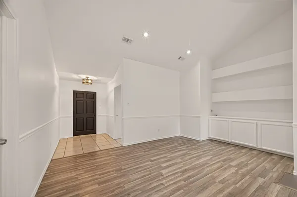 wooden floor in an empty room with a fireplace
