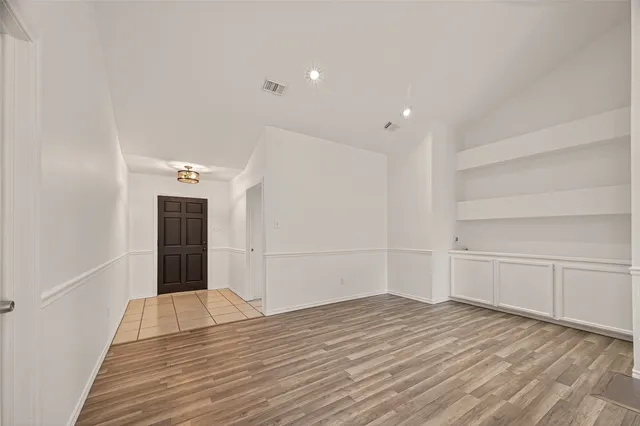 wooden floor in an empty room with a fireplace