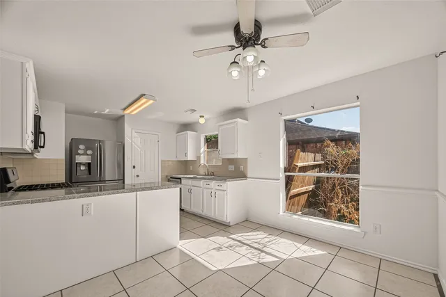 a kitchen with a sink stainless steel appliances and cabinets