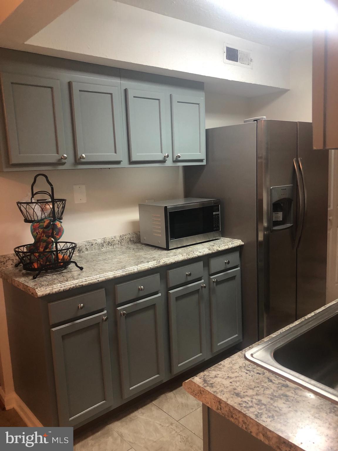 8015 Mandan Road, Unit T2 Greenbelt, MD 20770 - Photo 5 of 32 Updated kitchen cabinets and counters