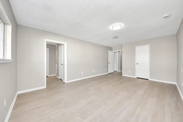 a view of a room with wooden floor