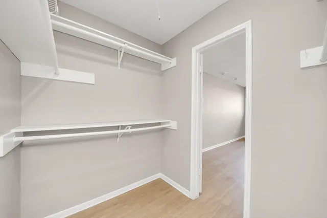 a bathroom with a double vanity sink a toilet and a mirror