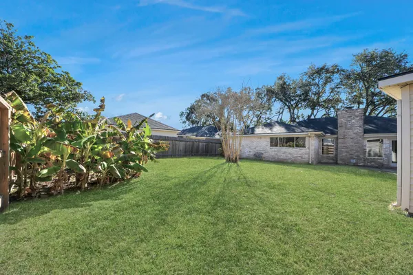 a front view of house with a garden