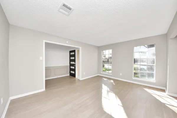 an empty room with windows and closet