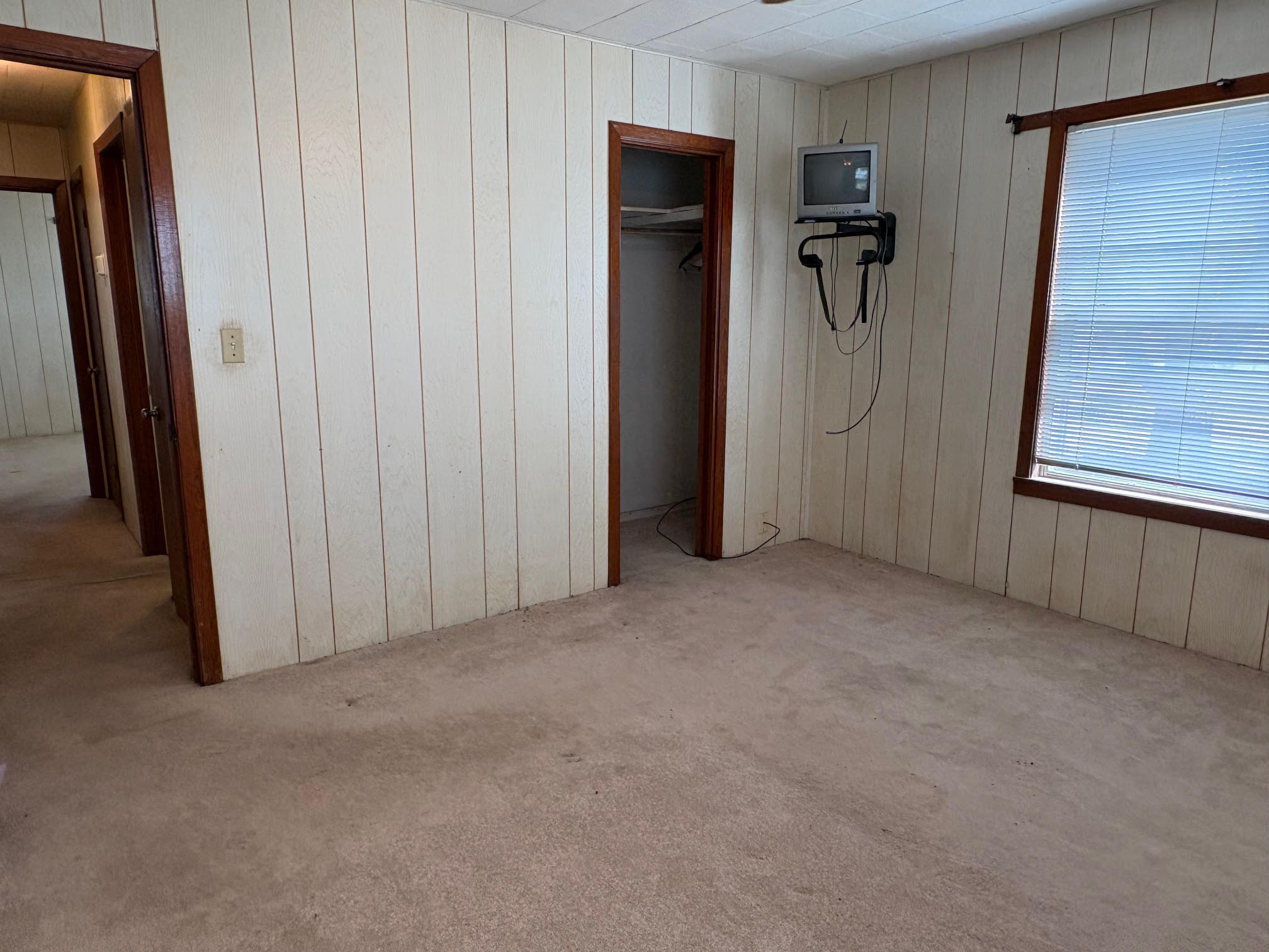 809 August Street El Campo, TX 77437 - Photo 23 of 27 a view of a closet area with hallway