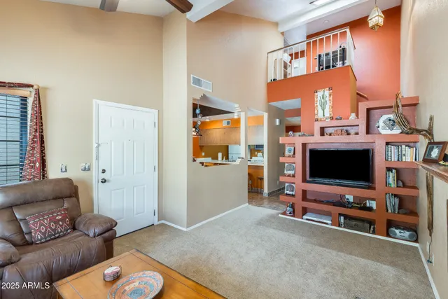a living room with furniture and a chandelier