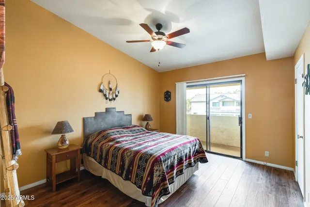 a bedroom with a bed and painting on the wall