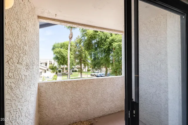 a view of a bedroom with a bed and wooden floor