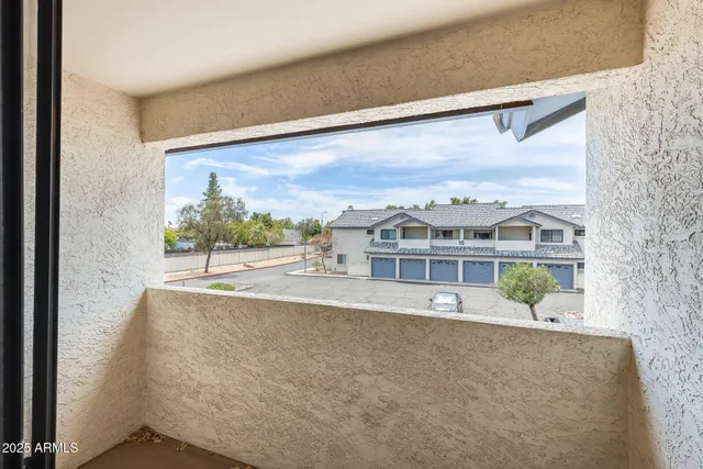 a view of a glass door with a yard from a window