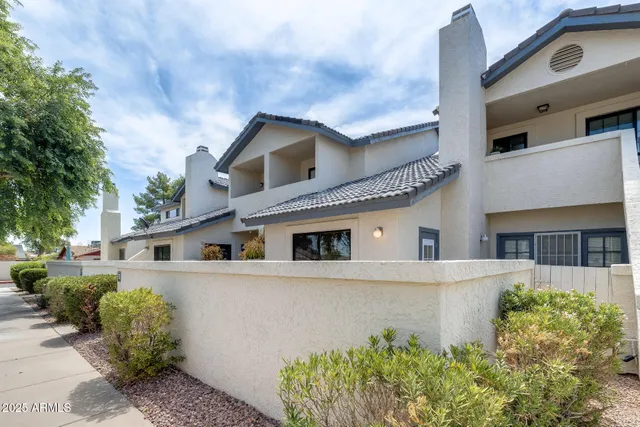 a front view of a house with potted plants