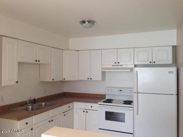 1333 West 5th Street, Unit D Tempe, AZ 85281 - Photo 2 of 7 a kitchen with white cabinets and white appliances