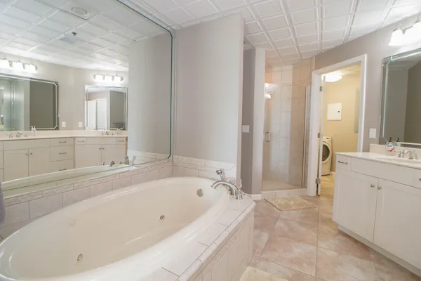 a spacious bathroom with a bathtub and a sink
