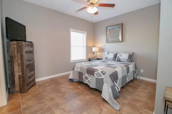 a bedroom with a bed and a flat screen tv