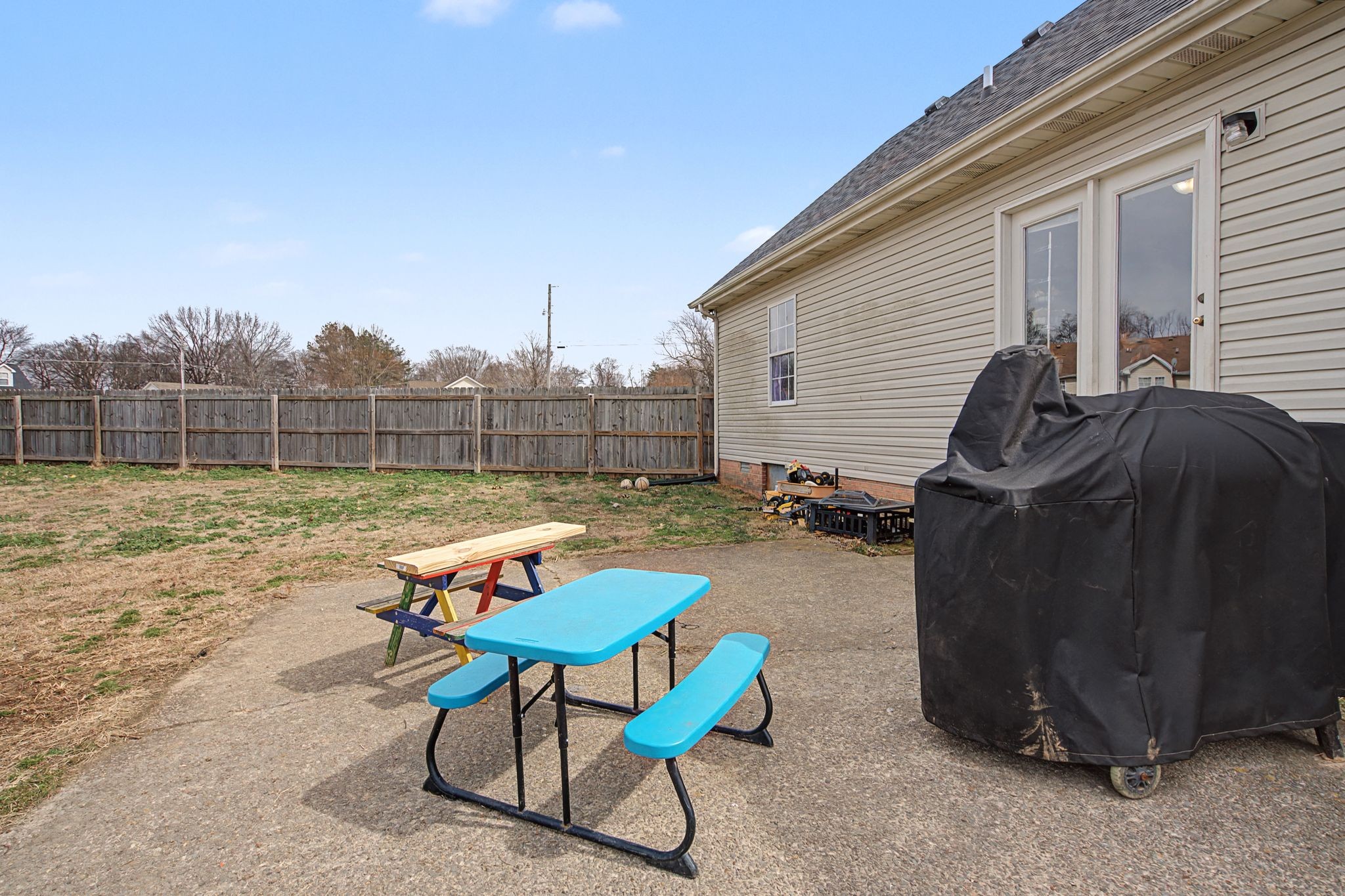 105 Cora Street Portland, TN 37148 - Photo 27 of 31 a backyard of a house with table and chairs