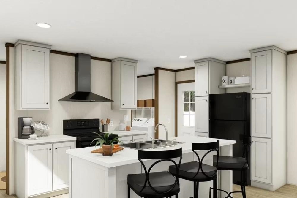 200 West 20th Street, Unit A146 Rifle, CO 81650 - Photo 3 of 7 a kitchen with stainless steel appliances a stove a sink cabinets and a dining table