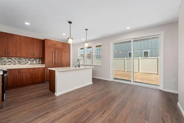 a kitchen with stainless steel appliances wooden floors and wooden cabinets