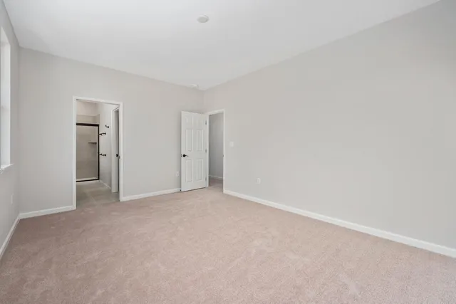 a view of an empty room and closet area