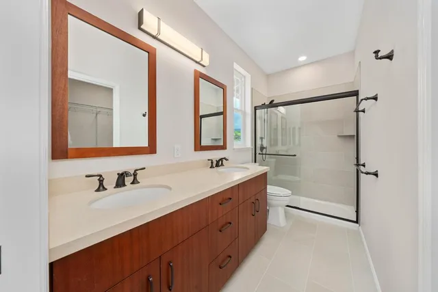 a bathroom with a double vanity sink mirror double and shower