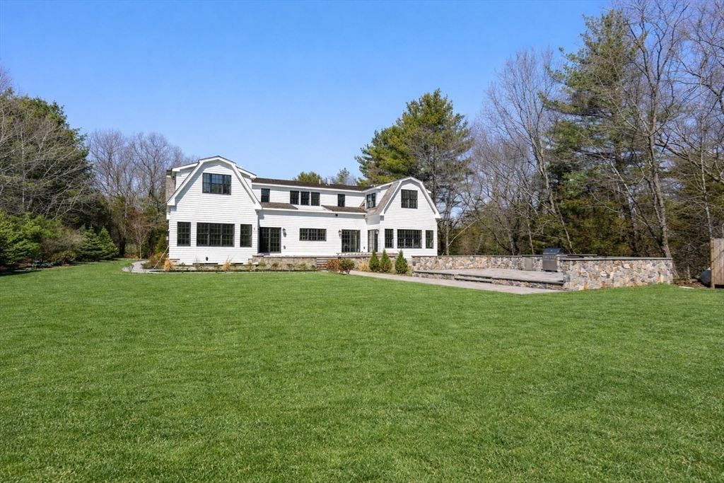 10 Hitching Post Lane Weston, MA 02493 - Photo 4 of 42 a front view of a house with a yard