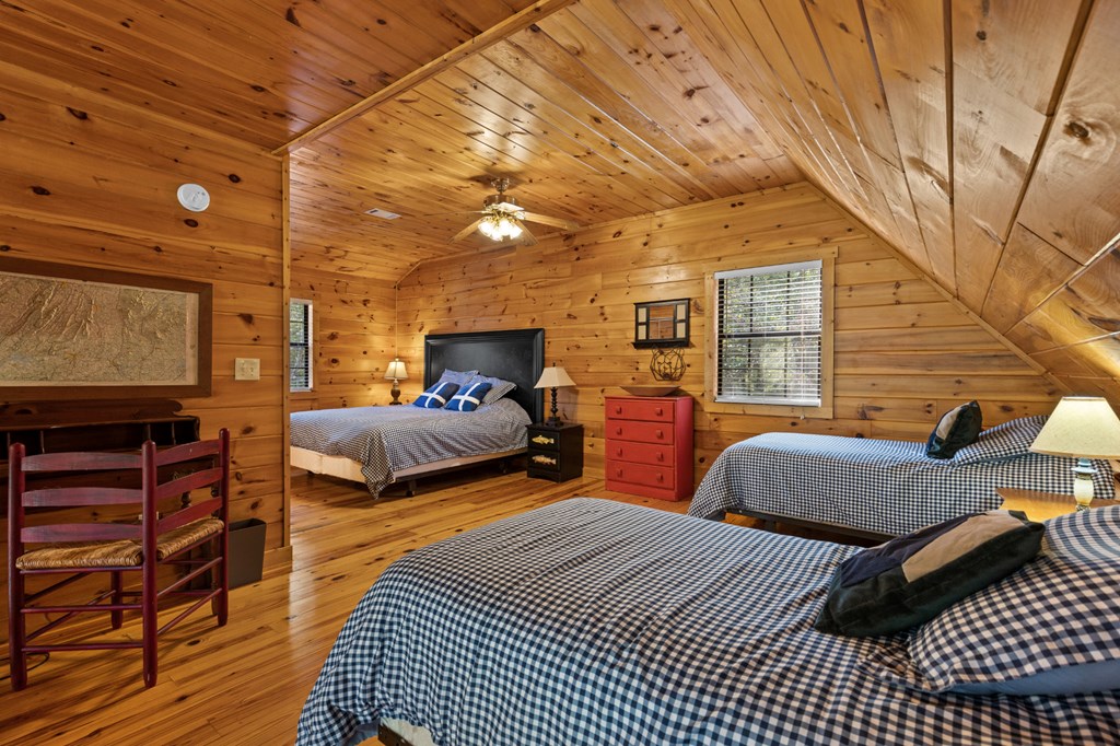 96 Holiday Court Ellijay, GA 30540 - Photo 31 of 51 a bedroom with furniture and wooden floor