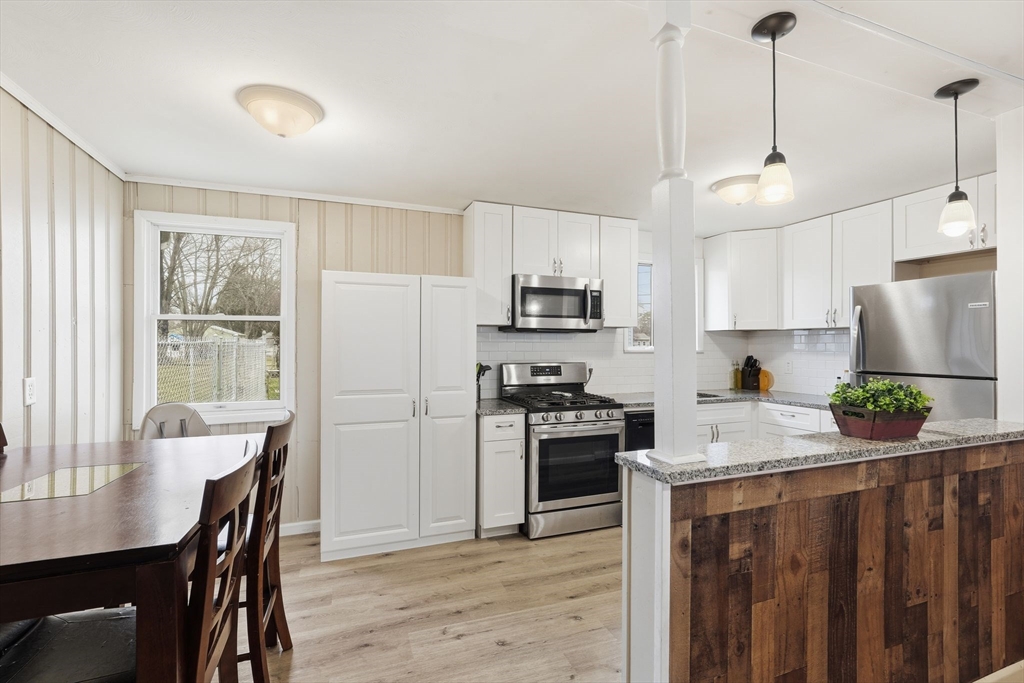 30 Jerilis Drive Springfield, MA 01119 - Photo 13 of 42 a kitchen with a refrigerator a stove a sink dishwasher a oven with a dining table and chairs