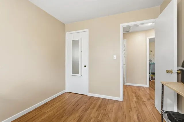 a bedroom with furniture and a wooden floor