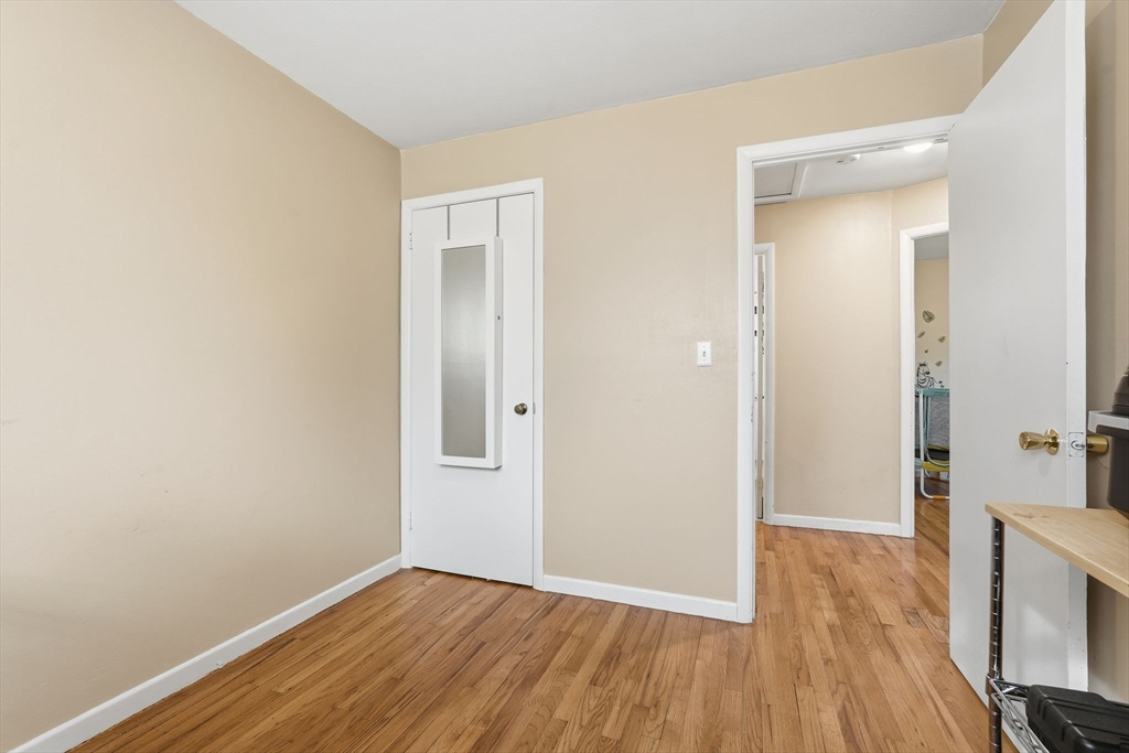 30 Jerilis Drive Springfield, MA 01119 - Photo 23 of 42 an empty room with wooden floor and windows