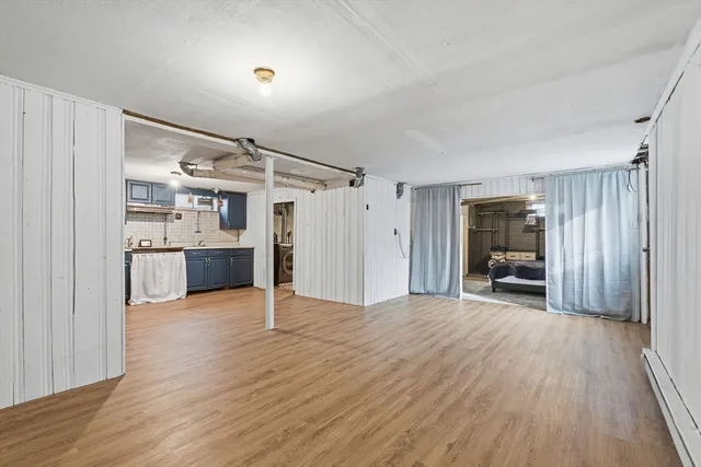 a view of empty room with wooden floor and stairs