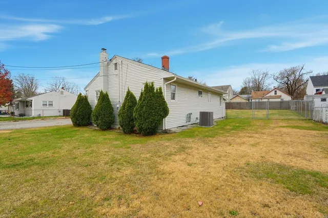 a view of a house with backyard and sitting area