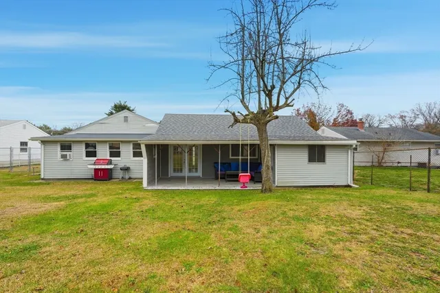 a front view of house with yard and swimming pool
