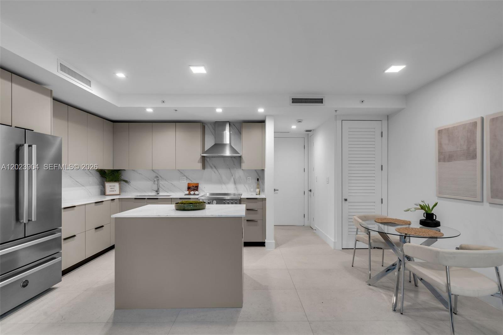 721 Southwest 11th Street, Unit G Miami, FL 33129 - Photo 11 of 40 a kitchen with stainless steel appliances a refrigerator a stove a sink a dining table and chairs