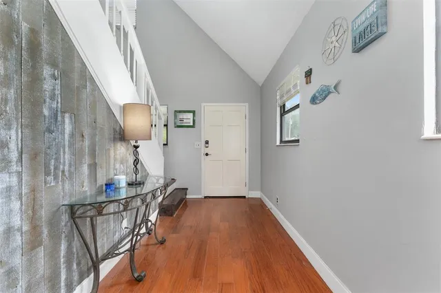 a view of hallway with wooden floor and stairs