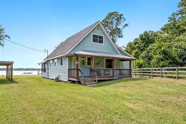 a view of a house with a yard and sitting area
