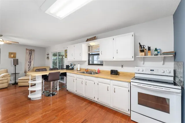 a kitchen with white cabinets and white appliances