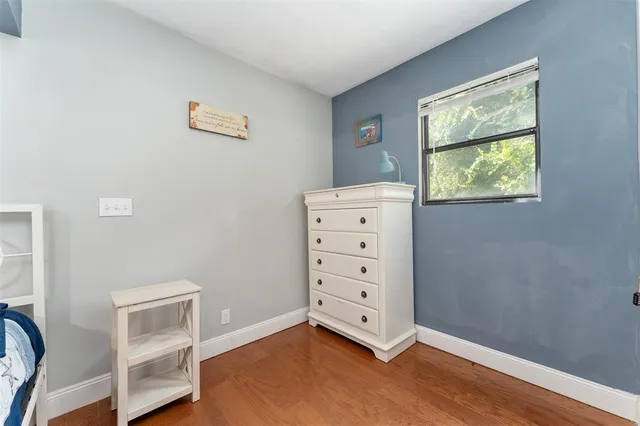 an empty room with windows and closet