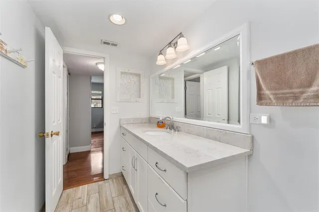 a bathroom with a sink and a mirror