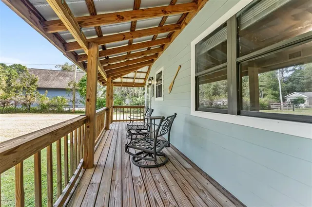 a view of balcony with furniture and wooden floor