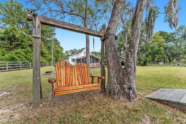 a view of a house with backyard and sitting area