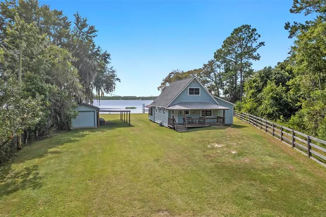 an aerial view of a house with yard