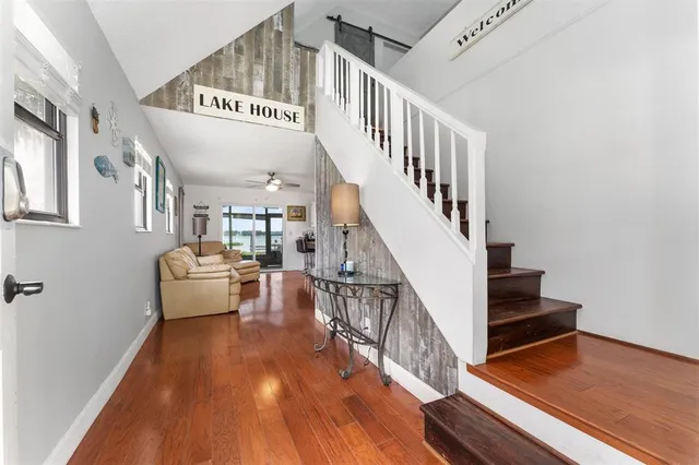 a view of entryway and hall with wooden floor