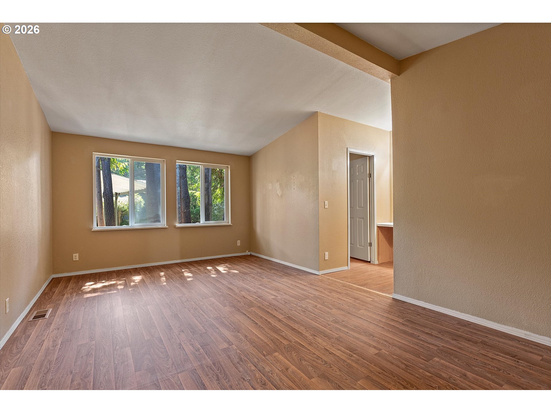 395 Seagrove Loop Lincoln City, OR 97367 - Photo 14 of 46 a view of an empty room with wooden floor and a window