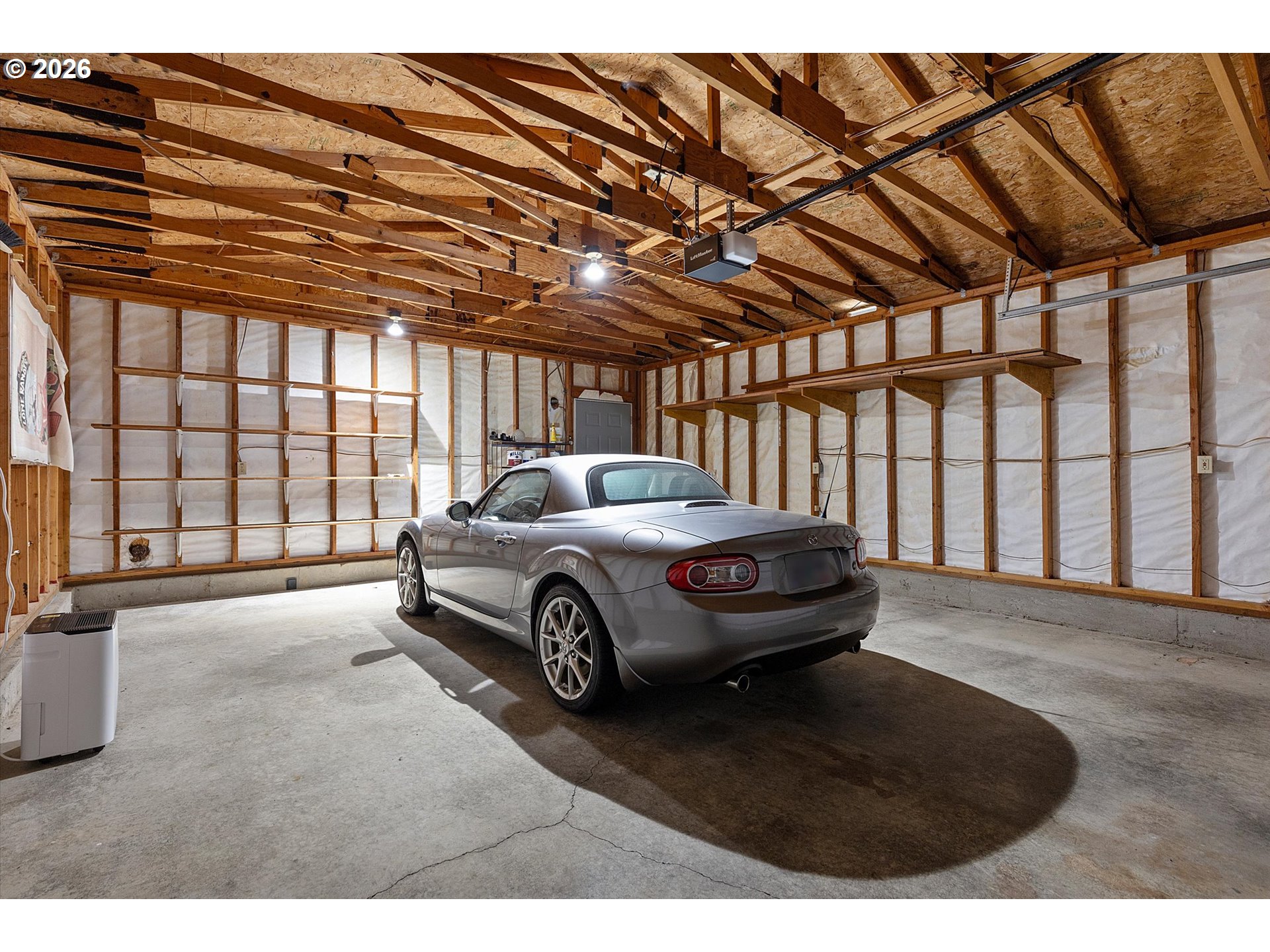 395 Seagrove Loop Lincoln City, OR 97367 - Photo 28 of 46 a car parked in front of a garage