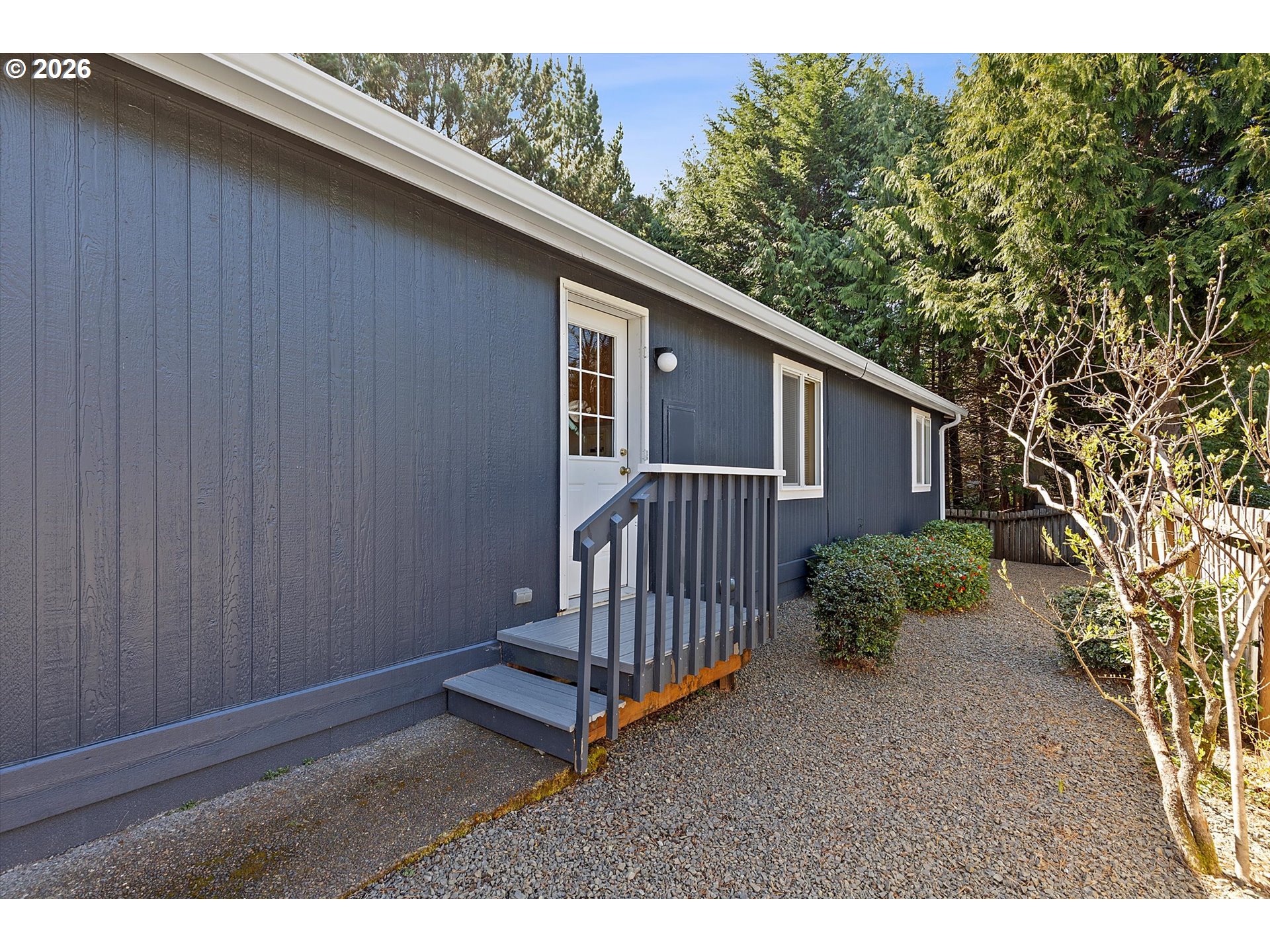 395 Seagrove Loop Lincoln City, OR 97367 - Photo 33 of 46 a backyard of a house with table and chairs
